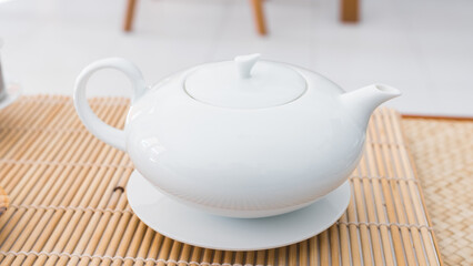 Rare teapot made of white porcelain. Beautiful professional teaware. Object precisely engineered to serve the best fresh tea.