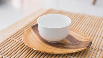 Beautiful white porcelain tea cup on a saucer close up