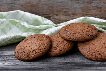 Oatmeal cookies with sugar on a vintage wood table, tea towel. Homemade baking.