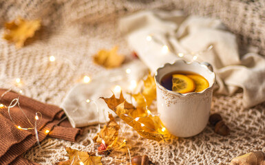 Autumn flatlay, Cup of warm tea fall style, fall scene with leaves, lights and acorns, cozy autumn aesthetic concept