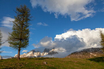 Alpine, covered with snow, the peaks are shrouded in clouds.