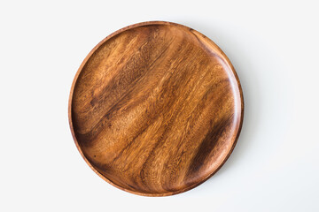 Wooden plate top view on white background