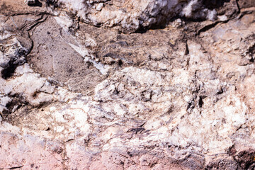 Natural stone background with cracks and scratches texture.