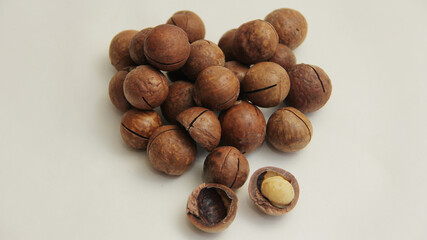 macadamia nuts lie in the form of a heart on a white background