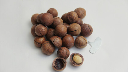 macadamia nuts lie in the form of a heart on a white background