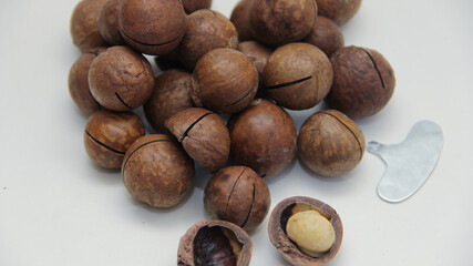 macadamia nuts lie in the form of a heart on a white background