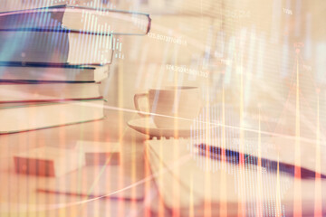 Obraz premium Double exposure of financial chart drawing and desktop with coffee and items on table background. Concept of forex market trading
