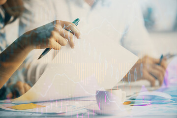 Double exposure of forex graph drawing over people taking notes background. Concept of financial...