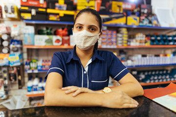 Young woman wearing face mask working in hardware store