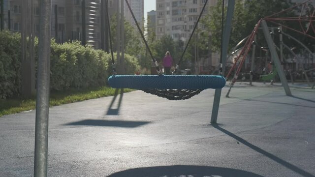 empty swings on the playground