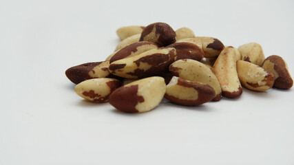 Brazil nuts scattered on a white background