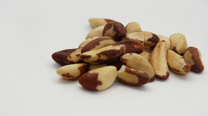 Brazil nuts scattered on a white background