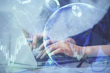 Multi exposure of woman hands typing on computer and financial graph hologram drawing. Stock market...