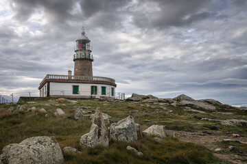 Fototapeta na wymiar Lighthouse on the hill in Corrubedo, Ribeira, Galicia, Spain