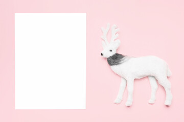 Christmas mockup with a toy deer on a pink background.