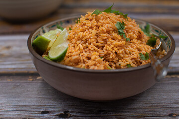 Authentic Mexican Spanish rice in ceramic bowl against gray table, copy space