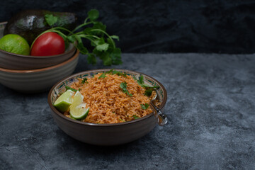 Authentic Mexican Spanish rice in ceramic bowl against gray table, copy space