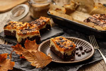 Delicious pumpkin cake with cheese cream and cacao or chocolate on the top