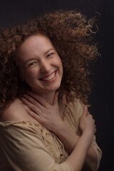 Fototapeta premium Studio portrait of a young woman with curly hair