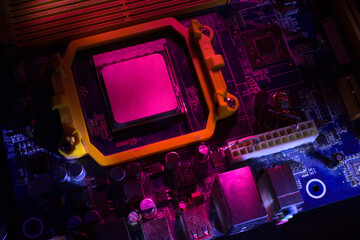 Close-up of electronic motherboard in an equipment repair shop with circuit details. Tinted in red and blue, copy space