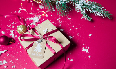 christmas gift  with pink ribbon on pink background
