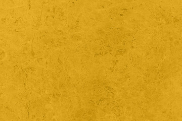 Saturated yellow colored low contrast Concrete textured background with roughness and irregularities. 2021 color trend.