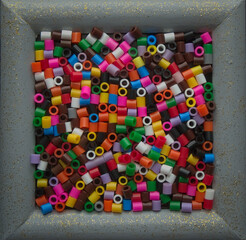 Box full of colored plastic pieces