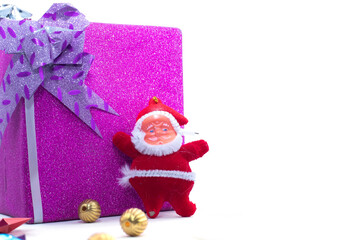 The statue of Santa Claus with the large gift box is isolated on a white background