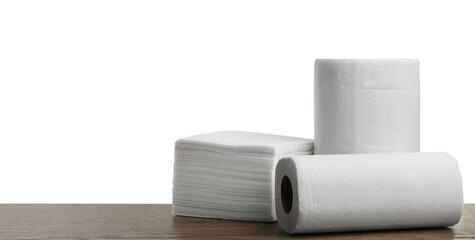 Rolls and stack of clean paper tissues on wooden table against white background