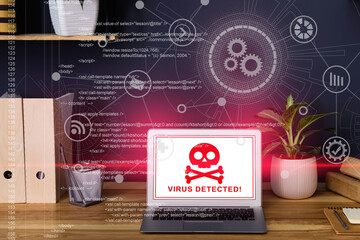 Warning about virus attack on laptop screen. Workplace in office