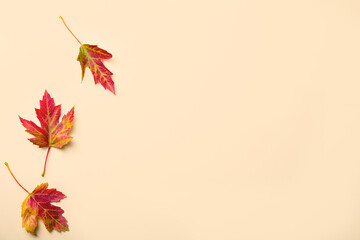 Colorful autumn leaves on beige background, flat lay. Space for text