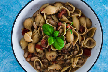 plant-based food, vegan mushroom sauce pasta with butter beans and chopped tomatoes