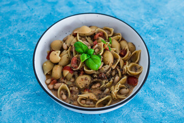 plant-based food, vegan mushroom sauce pasta with butter beans and chopped tomatoes