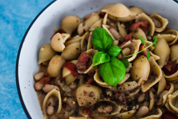 plant-based food, vegan mushroom sauce pasta with butter beans and chopped tomatoes