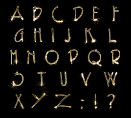 Set with letters made of sparkler on black background