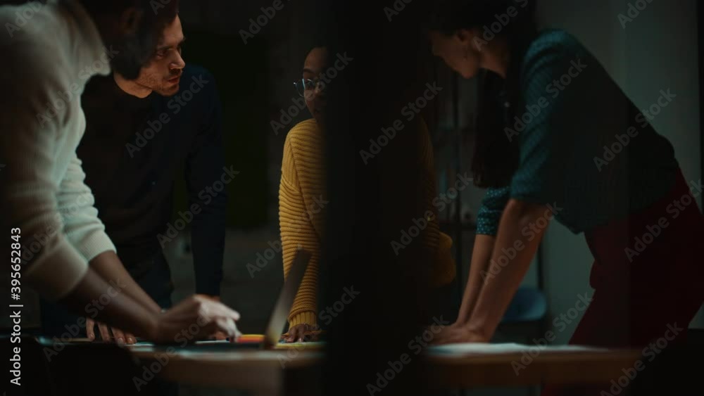 Poster Diverse Multiethnic Team are Having a Conversation in a Meeting Room Behind Glass Walls in a Creative Office. Colleagues Lean On a Conference Table and Discuss Business, App User Interface and Design.