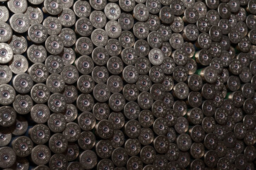 Pattern of 12 gauge cartridges for shotgun bullets. Shells for hunting rifle close up. Backdrop for...