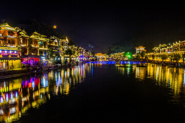 Fototapeta na wymiar Evening view of Fenghuang Ancient Town with Tuo river, Hunan province, China