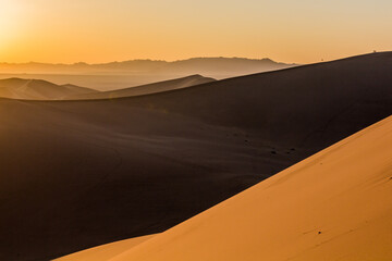 Fototapeta na wymiar Sunrise at Singing Sands Dune near Dunhuang, Gansu Province, China