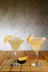 Frozen Margarita mixed drink with lime slice on plain background close up