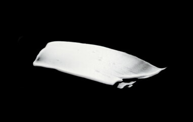 White whipped cream isolated on black background. Meringue on black.