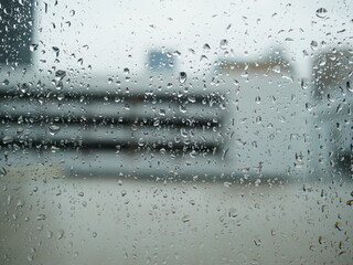 Naklejka na ściany i meble rain water drops on the window glass in rainy day. 