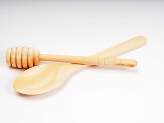 Picture of wooden honey dipper on a white isolated background