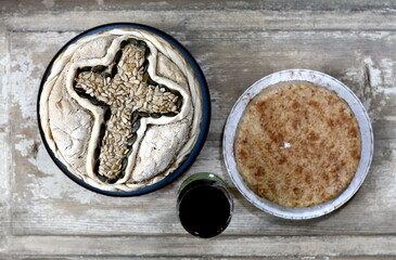 Homemade decorated Serbian slava bread on the rustic wooden table.