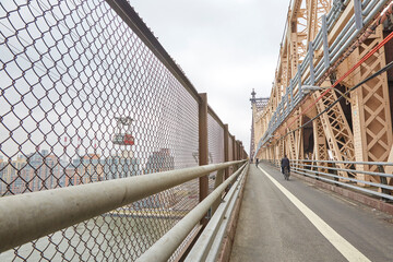 Walking and biking lanes on a bridge going over the East River from Manhattan to Queens in NYC