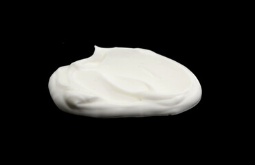 White whipped cream isolated on black background. Meringue on black.