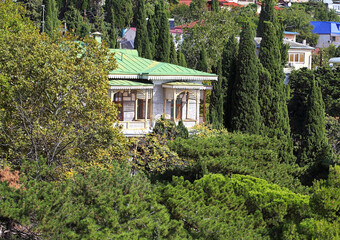 Fototapeta na wymiar Summer house among cypresses