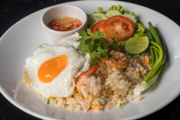 Thai fried rice with shrimps, fried egg and chili sauce