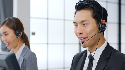 Asian call center team, customer service, telesales in formal suit wearing headset or headphone...