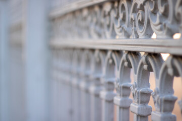 Historical white iron fence with bright background